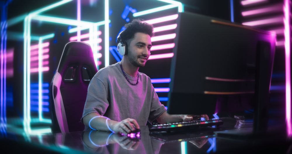 Cinematic Footage of a Young Male Gamer Playing Online Video Game on a Computer in a Cyberpunk Digital Neon World.