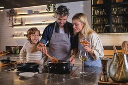 Happy family cooking food together in kitchen