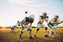 Football team passing the ball to each other during practice