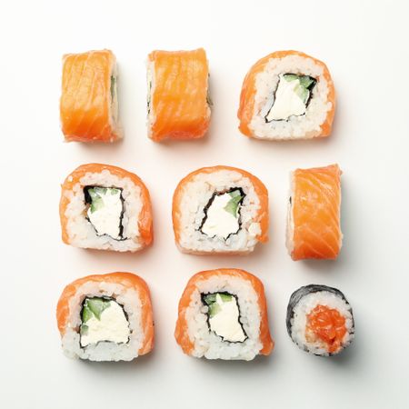 Flat lay with sushi rolls on light background. Japanese food