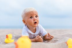Baby boy playing with rubber ducks