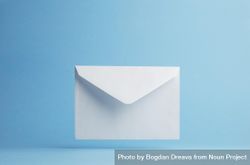 Floating blank envelope over light blue background 0VvKj0