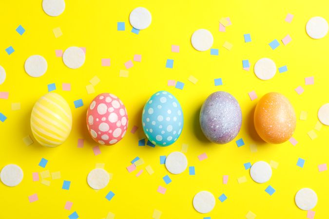 Decorative Easter eggs on color background, space for text. Top view