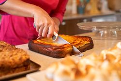 Crop person cutting freshly baked pie