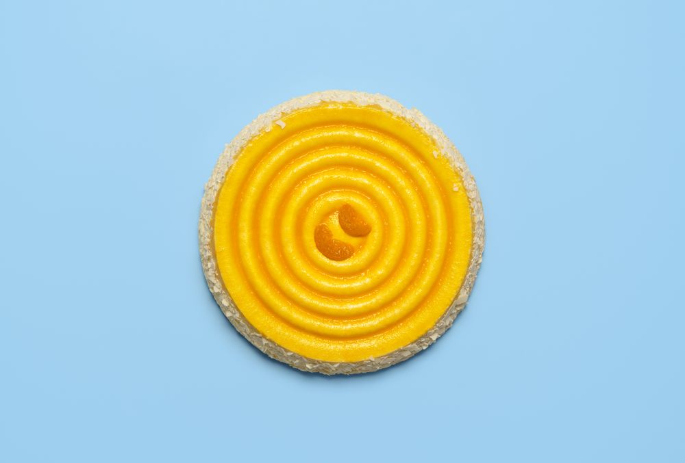 Tangerine cake isolated over blue background