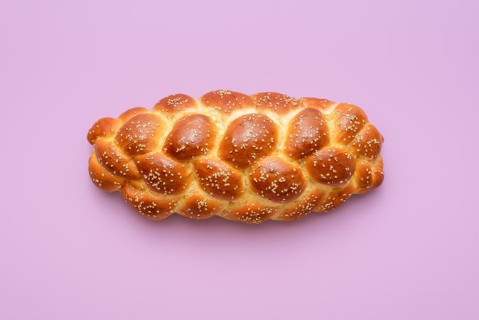Challah bread above view, isolated on a purple background