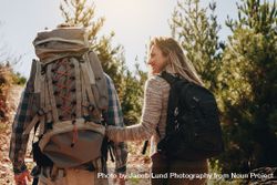 Couple with backpacks hiking on mountain 48Bd3X
