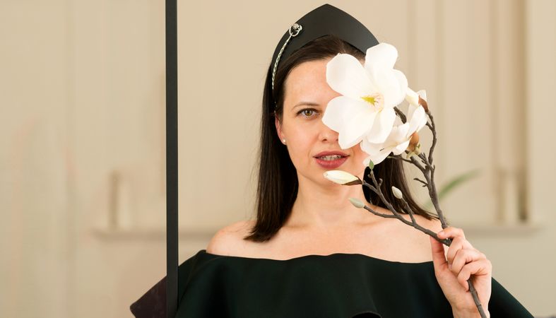 Woman posing with a white flower