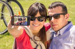 Couple in love taking a selfie photo on the park