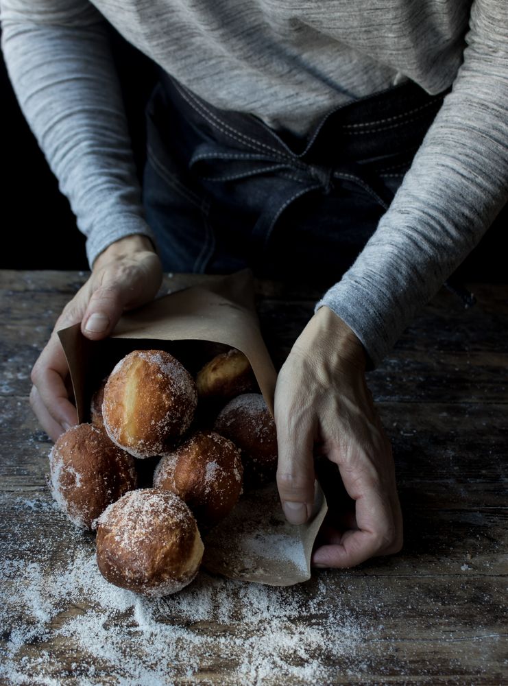 Person near baked cakes on table