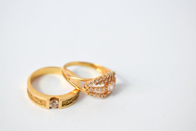 Two gold wedding rings together on plain table with space for text