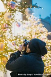 Man taking a photo of Christmas tree 5nmmm0