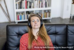 Blonde young woman relaxing and listening to music on headphones 4BaReM