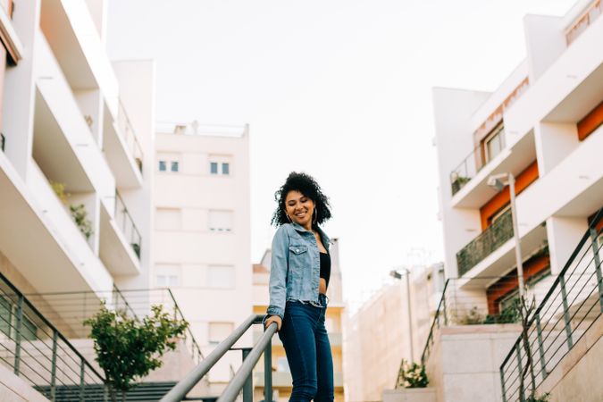 Trendy young female laughing on stairs