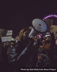 London, England, United Kingdom - March 16, 2021: Woman with speaker phone at large protest 0WK7O0