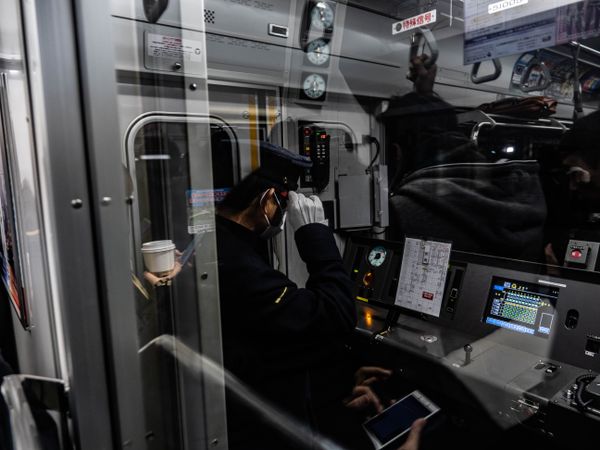 Back view of train captain in control room