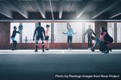 Multi-ethnic group of people doing different exercises backlight by a sunny window 0voqR5