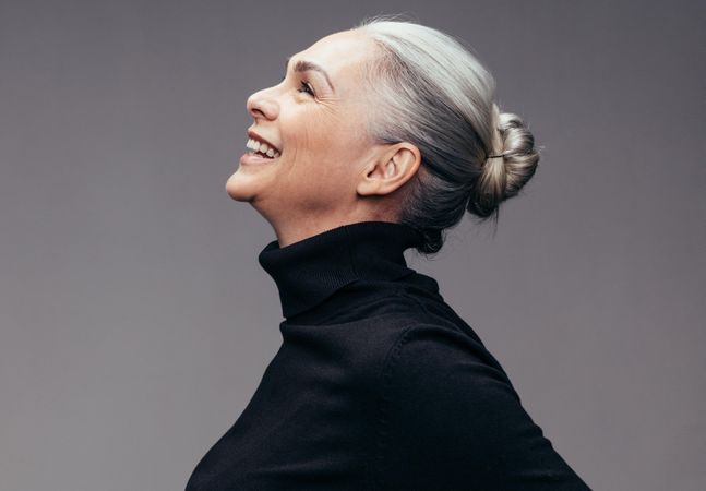 Profile view of mature woman looking up smiling