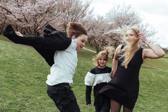 Mother and children near blooming trees