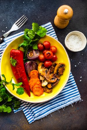 Plate of grilled vegetable on striped blue napkin with copy space
