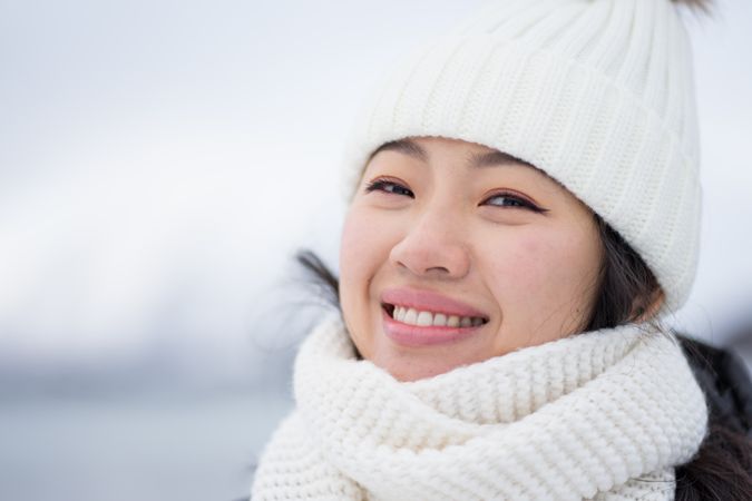Joyful young woman in warm clothes