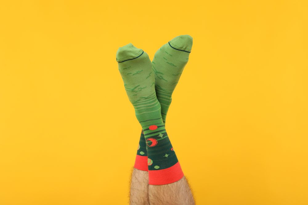 Casual clothes and wearing concept - socks, clothes for foot