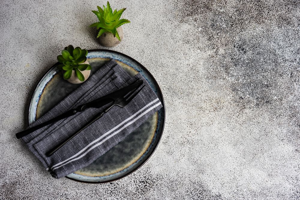 Table setting on concrete background with succulents