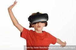 Little girl looking in VR glasses and gesturing with his hands 0Prql4