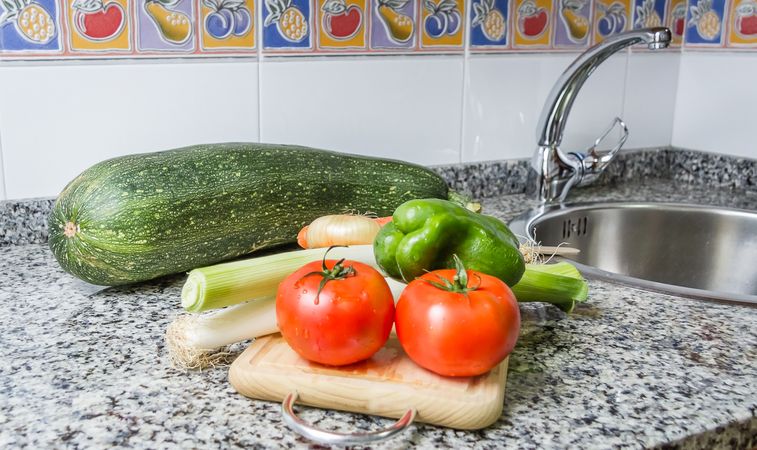Fresh vegetables on cutting board in the kitchen