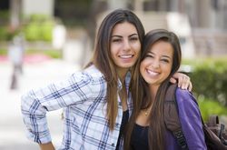 Female Students With Backpacks on School Campus
