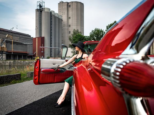 Old-timer red Cadillac and a young woman