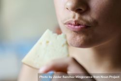 Crop teenage girl holding eaten cheese slice at home 5kRE9o
