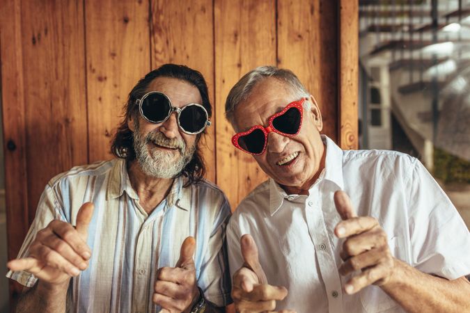 Older men wearing funny sunglasses looking at camera