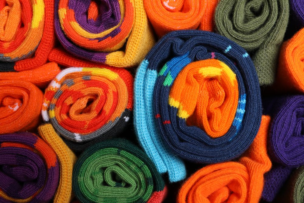 Casual clothes and wearing concept - socks, clothes for foot