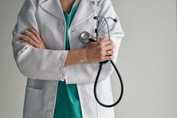 Crop doctor in medical robe with stethoscope