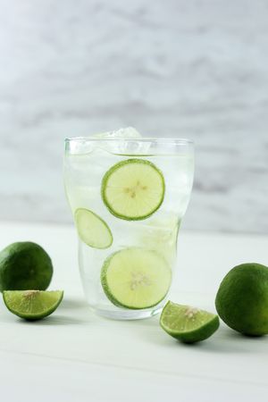 Mojito Cocktail in a Tall Clear Glass with Lime, Soda and Ice.