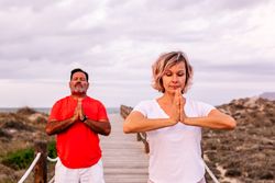 Couple practicing martial arts on lumber path