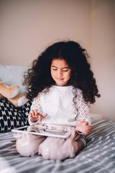 Little girl playing on a tablet