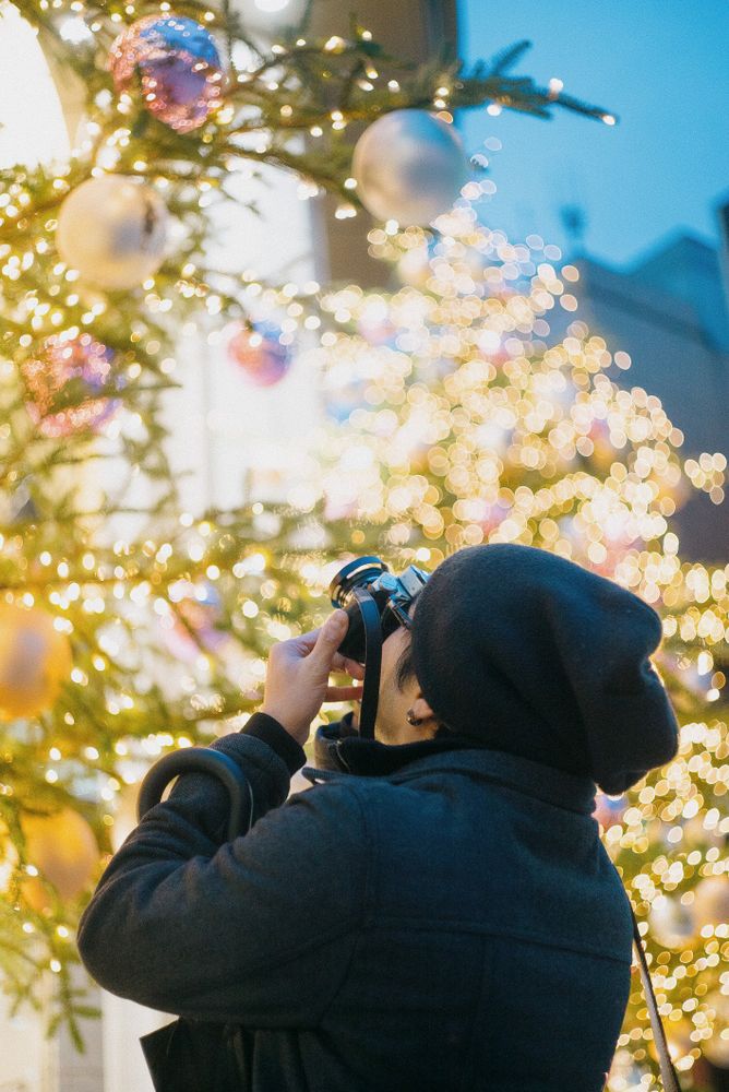 Man taking a photo of Christmas tree