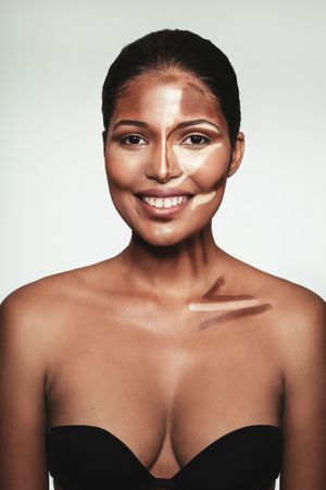 Smiling woman in demo of contouring make up