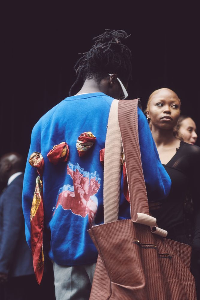 London, England, United Kingdom - September 18 2021: Back of male in sweater with weaved scarf
