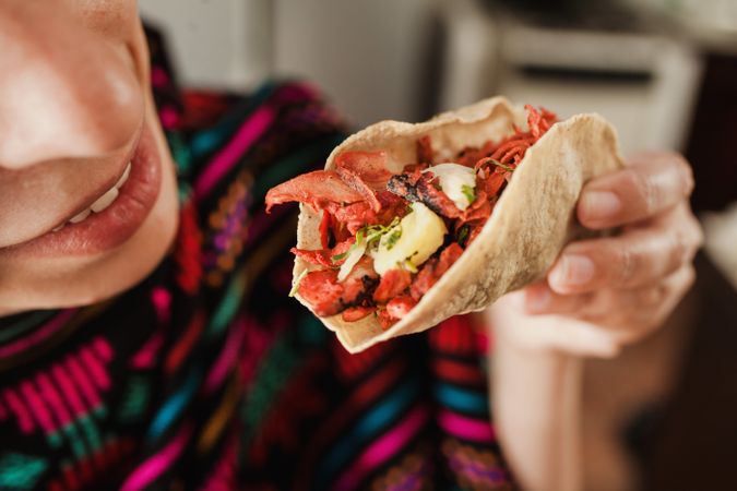 Crop woman with taco al pastor