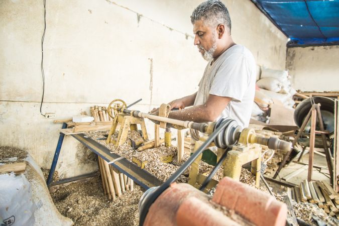 Man using woodworking machine at workplace