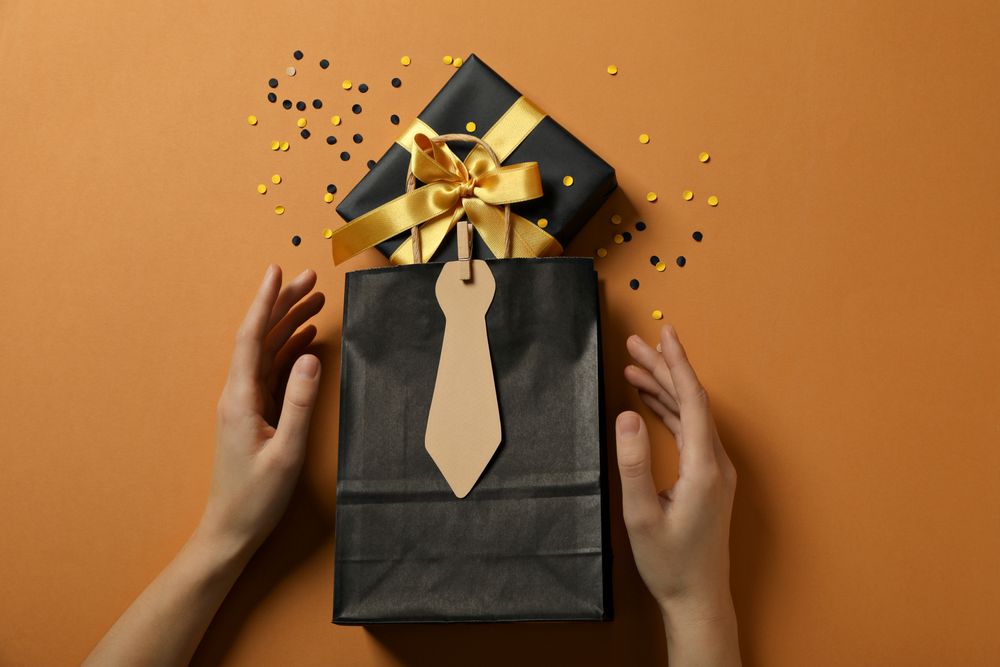 A gift for father, for the holiday, on an orange background.