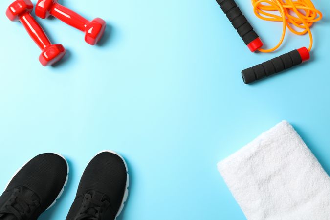 Flat lay composition with sport lifestyle accessories on blue background