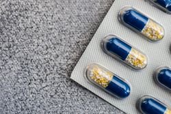 Close up of pills on grey counter with copy space