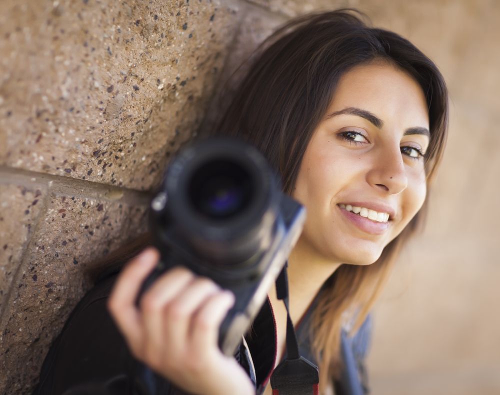 Young Adult Female Photographer Holding Camera