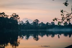 Slight fog above peaceful lake in early morning