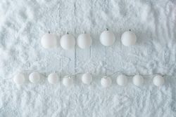 Wooden table background with snow and lights ball decoration