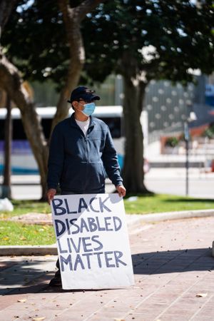 Los Angeles, CA, USA — June 16th, 2020: man at solidarity rally holding homemade sign